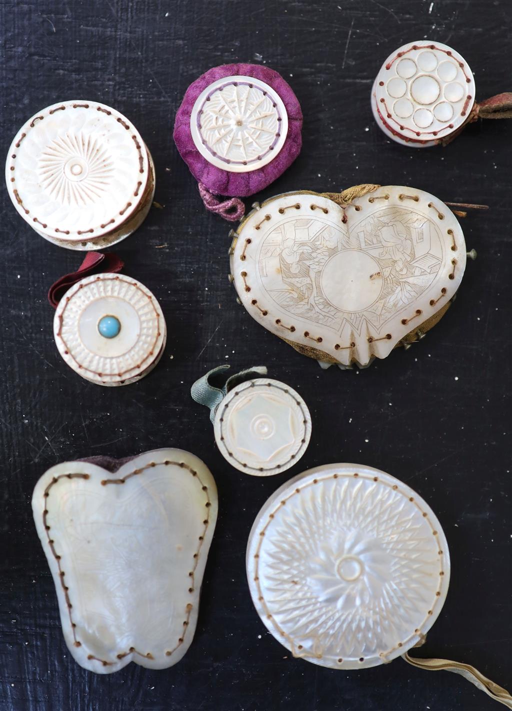 Eight assorted 19th century mother of pearl mounted pin cushions